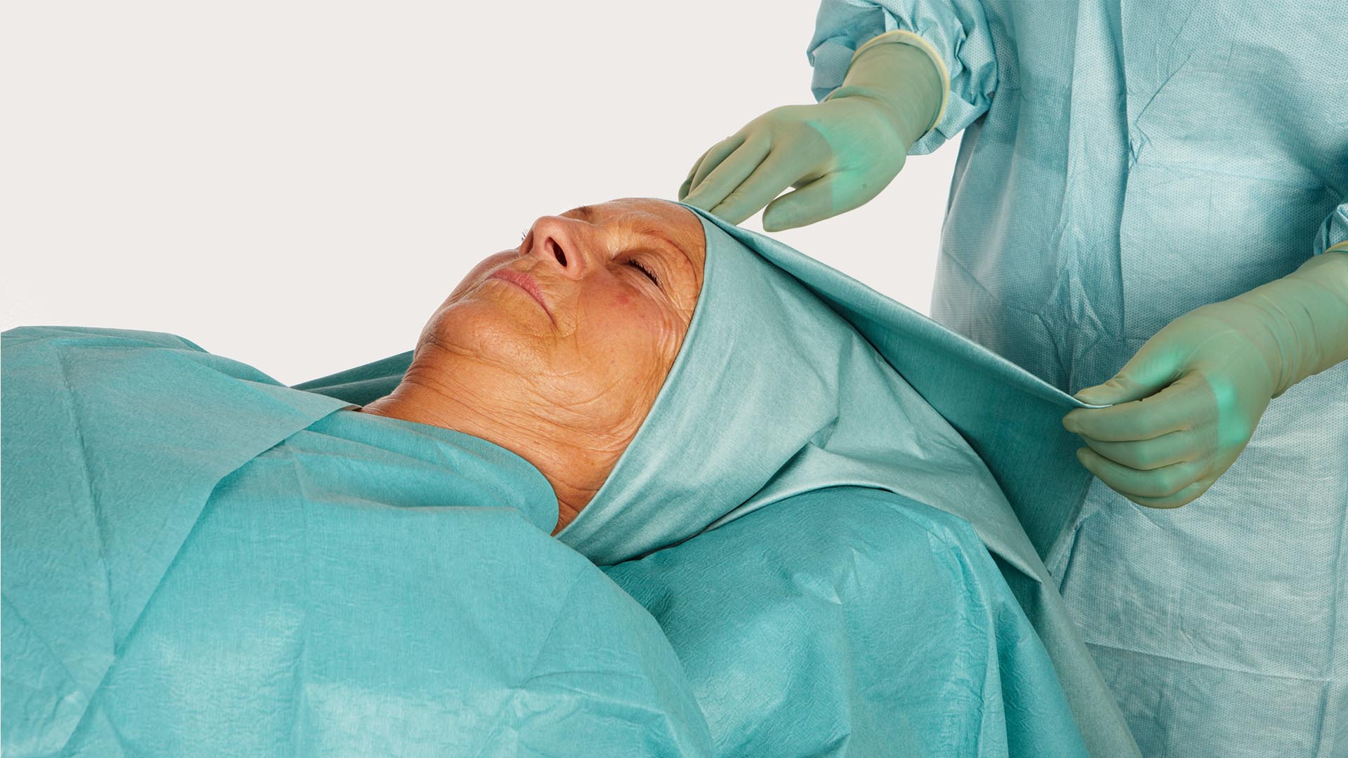 Hlava pacientky zarouškovaná pomocí ORL roušky BARRIER